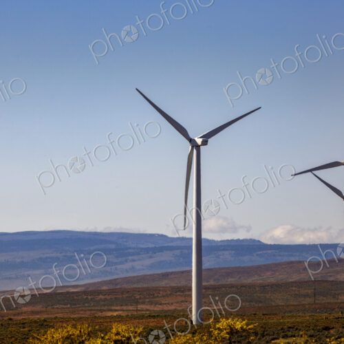 Wind turbines on the rolling hills of Kittikas county in Washington state, tall white… Wind turbines on the rolling hills of Kittikas county in Washington state, tall white…