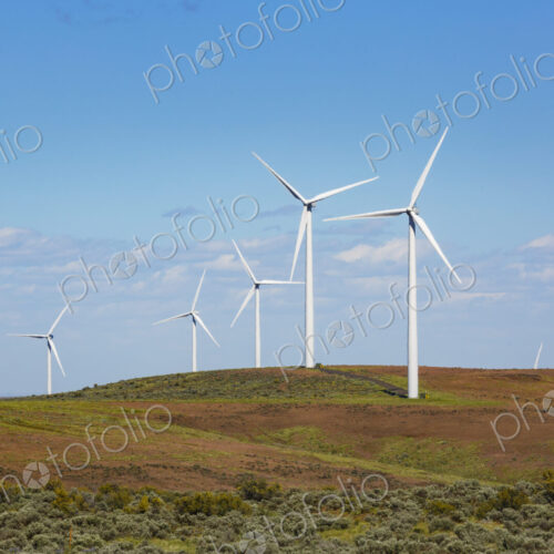 Wind turbines on the rolling hills of Kittikas county in Washington state, tall white… Wind turbines on the rolling hills of Kittikas county in Washington state, tall white…