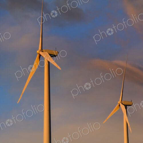 Wind turbines under sunset sky Wind turbines under sunset sky
