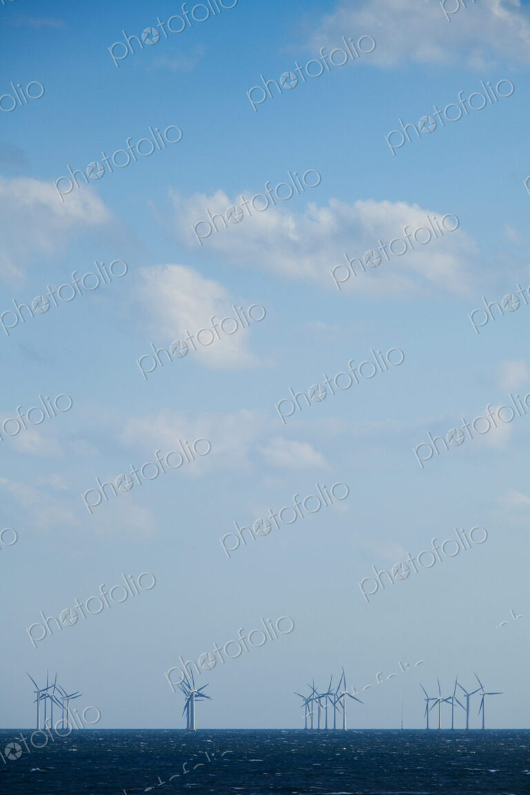 Windmills, turbines in the water in the Oresund Strait on the Baltic sea between…