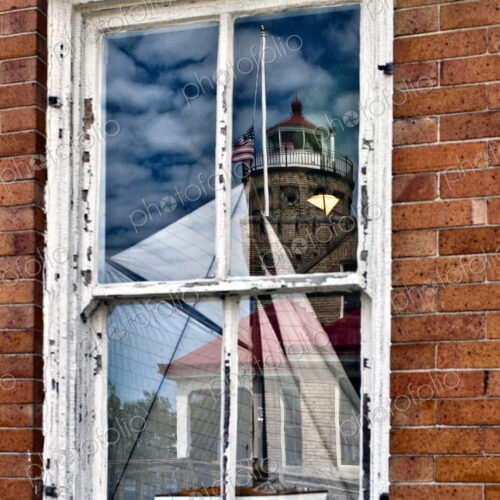 Window Reflection of Lighthouse and Boat