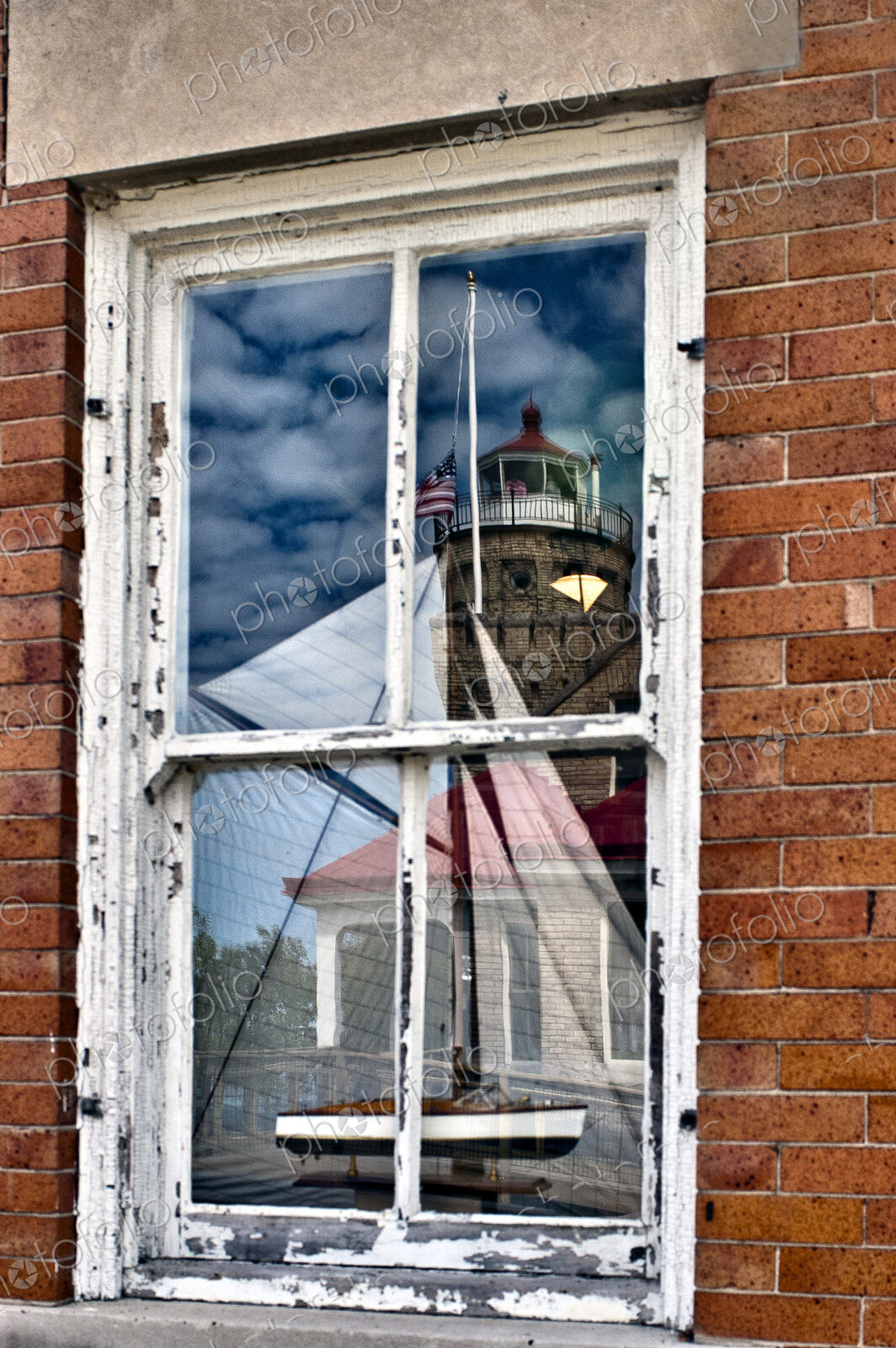Window Reflection of Lighthouse and Boat
