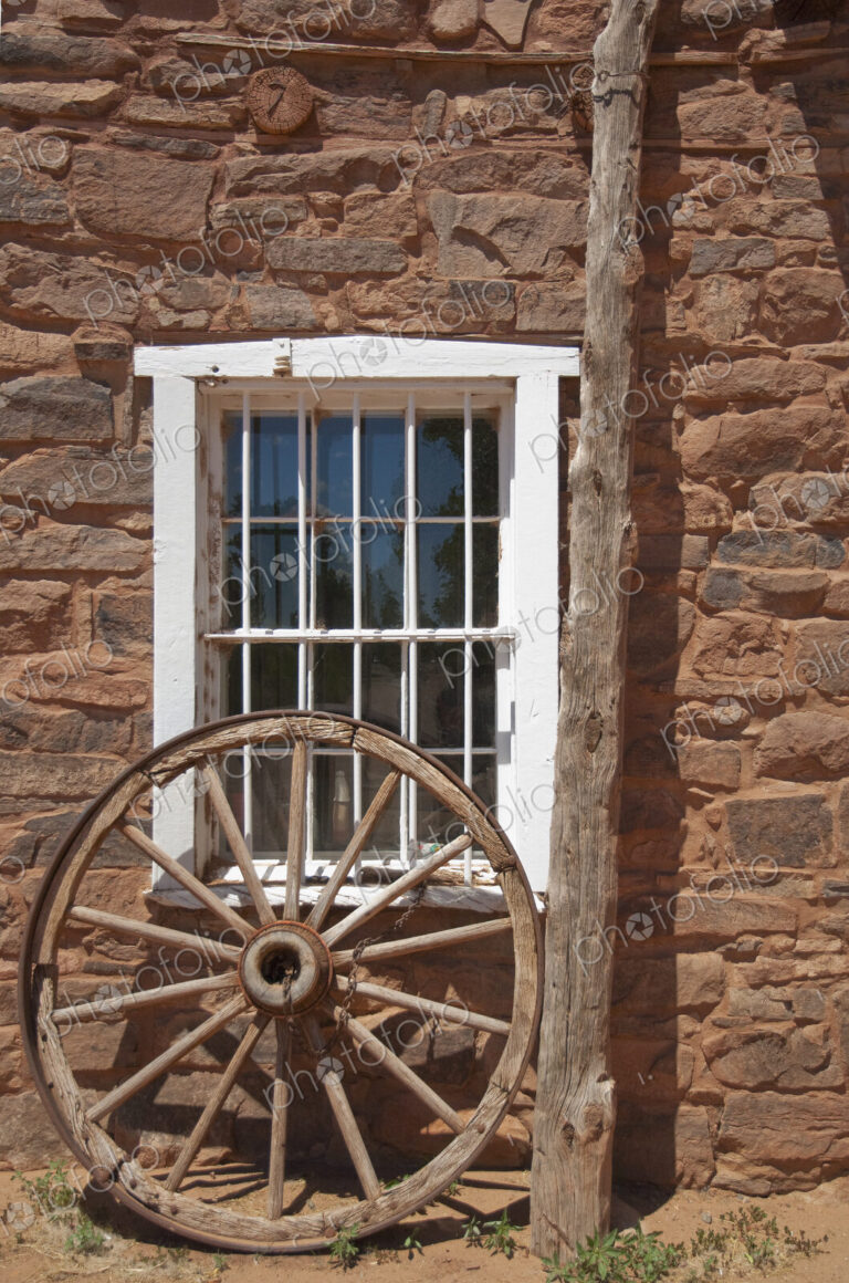 Window in Stone Building With Wagon Wheel