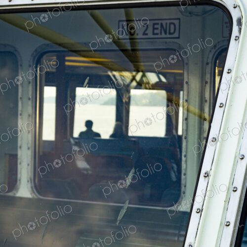 Window view of two people on the Spokane ferry, WA USA