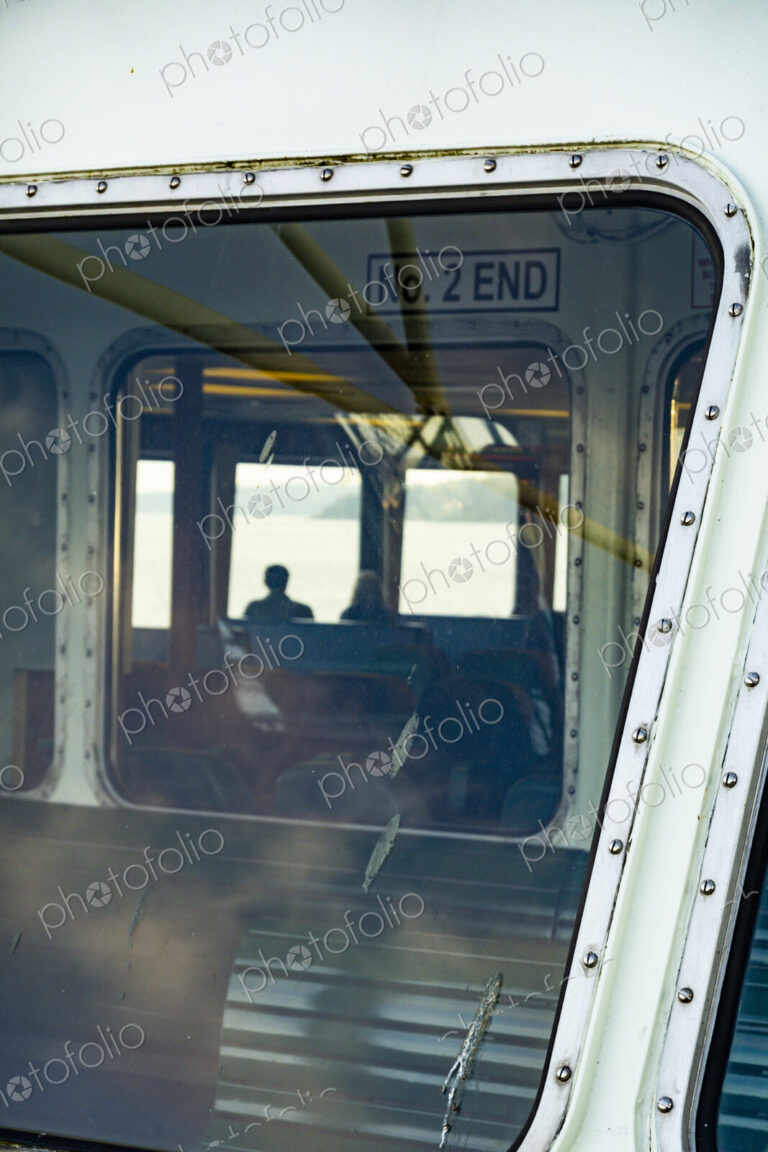 Window view of two people on the Spokane ferry, WA USA