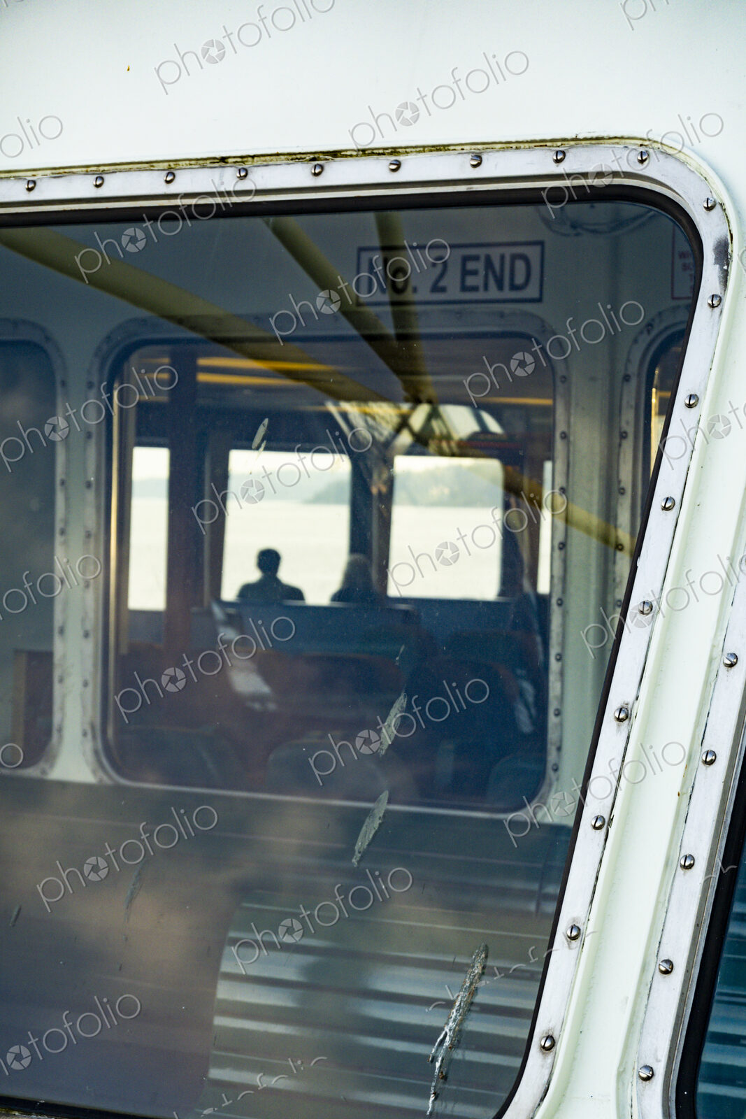 Window view of two people on the Spokane ferry, WA USA