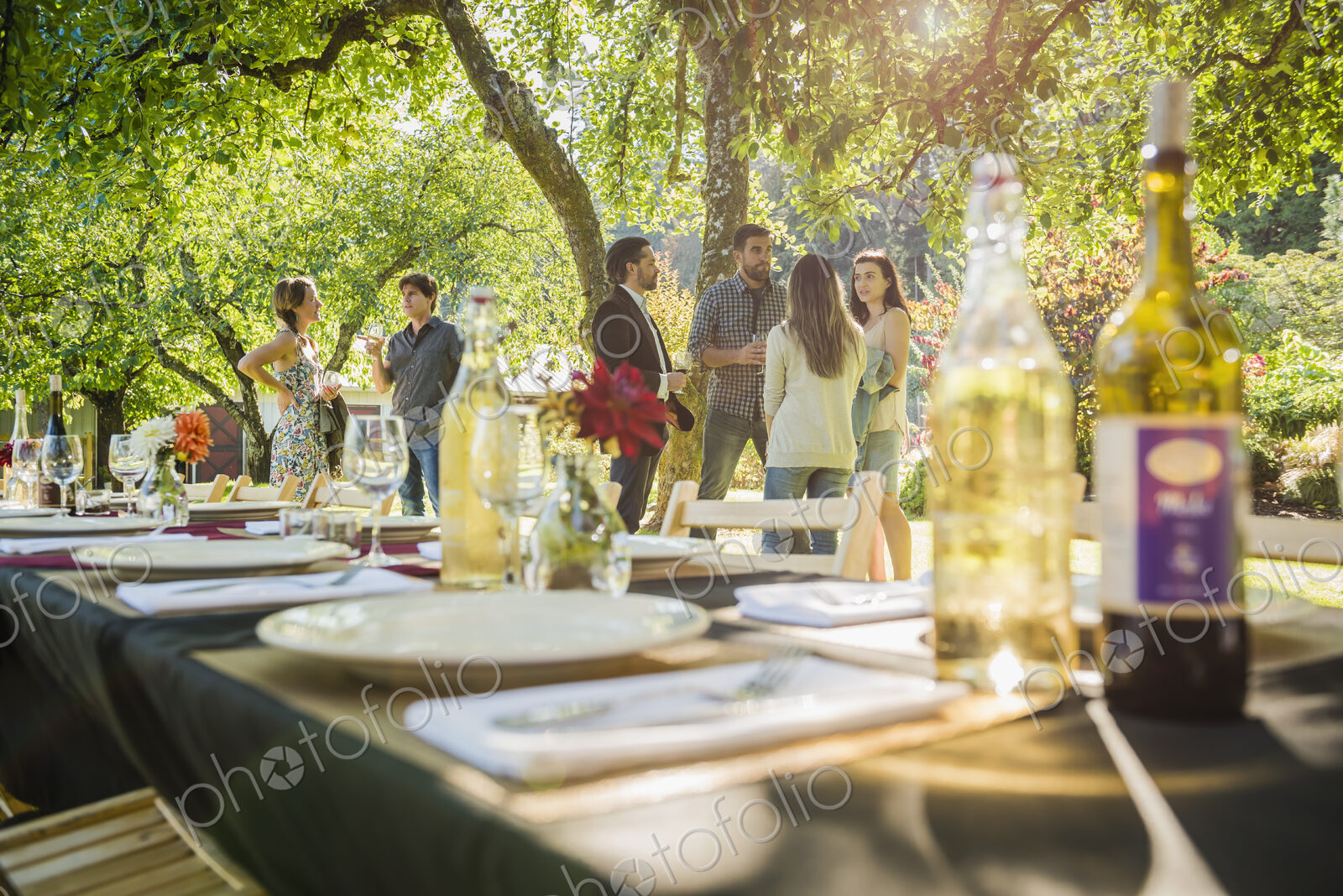 Wine bottles on table at party outdoors