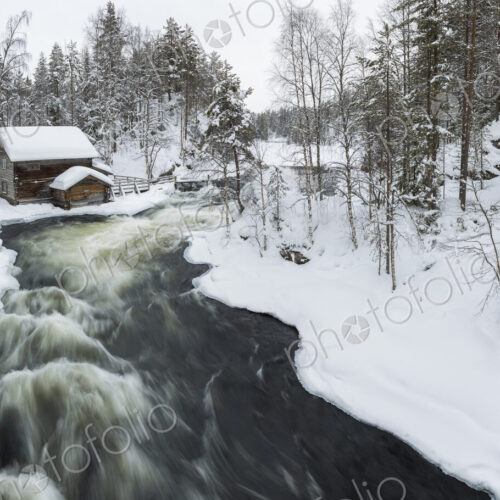 Winter landscape with log cabin and rapid in forest with snow-covered trees. Winter landscape with log cabin and rapid in forest with snow-covered trees.