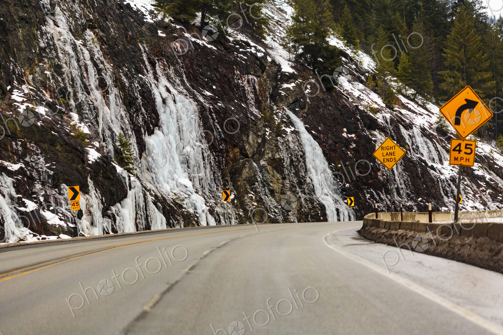 Winter on Highway 97 over Blewett Pass, cliffs and a sharp bend in the road.