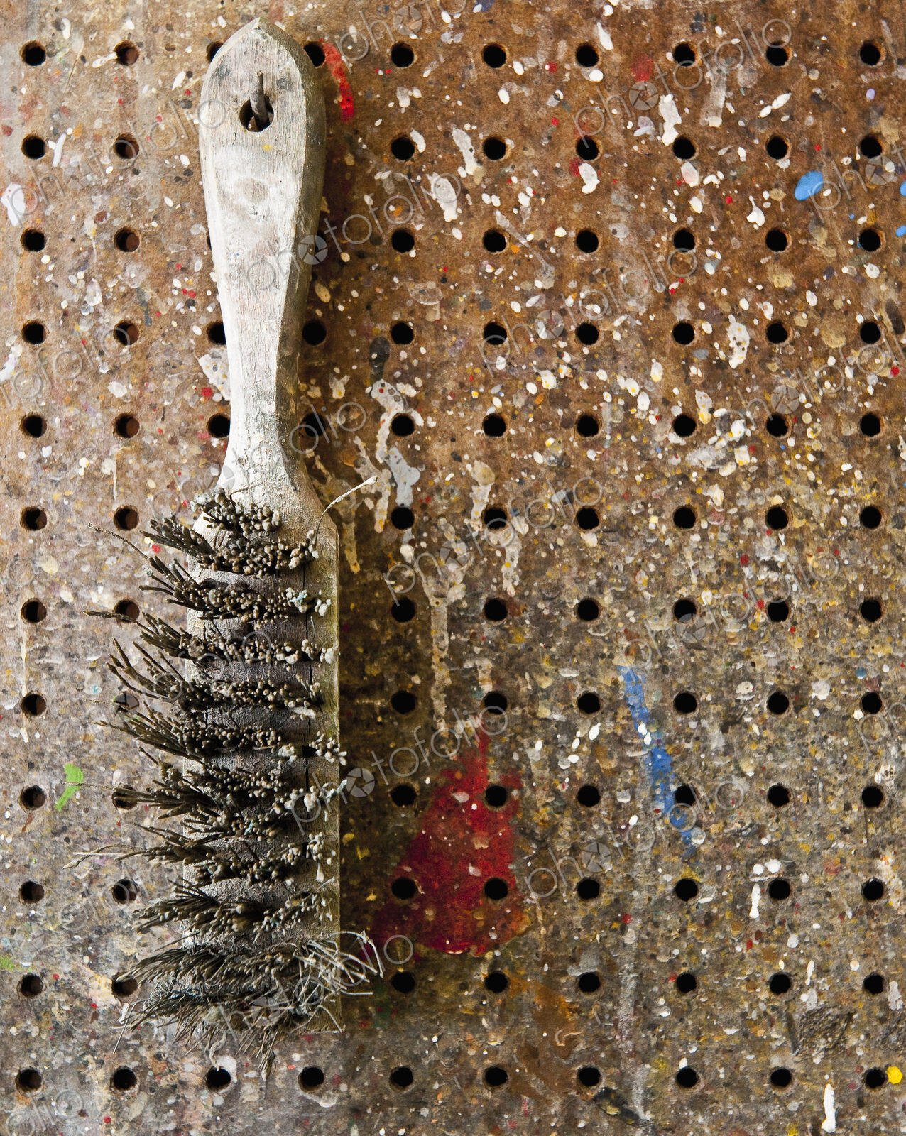 Wire Brush Hanging On a Pegboard