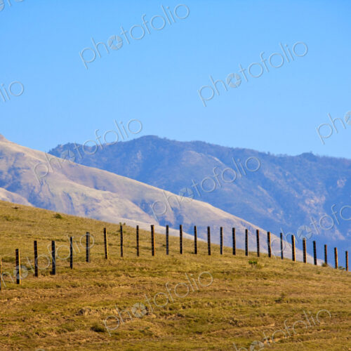 Wire Fence Extending over Hill Wire Fence Extending over Hill
