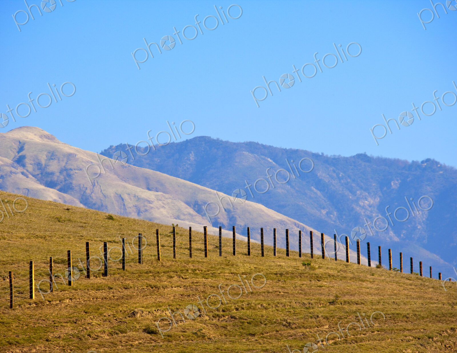 Wire Fence Extending over Hill