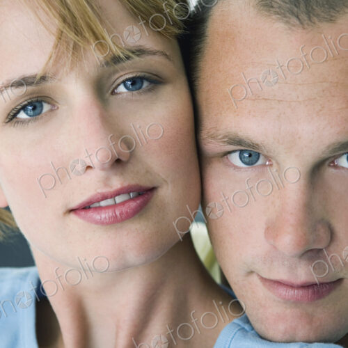 Woman and man smiling at camera with white background. Woman and man smiling at camera with white background.