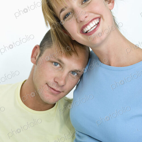Woman and man smiling at camera with white background. Woman and man smiling at camera with white background.