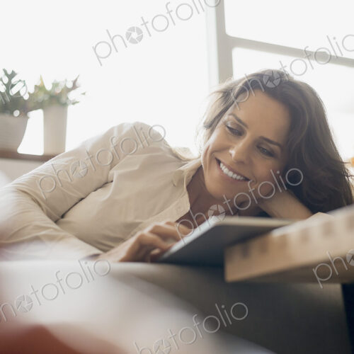 Woman at home using electronic tablet Woman at home using electronic tablet