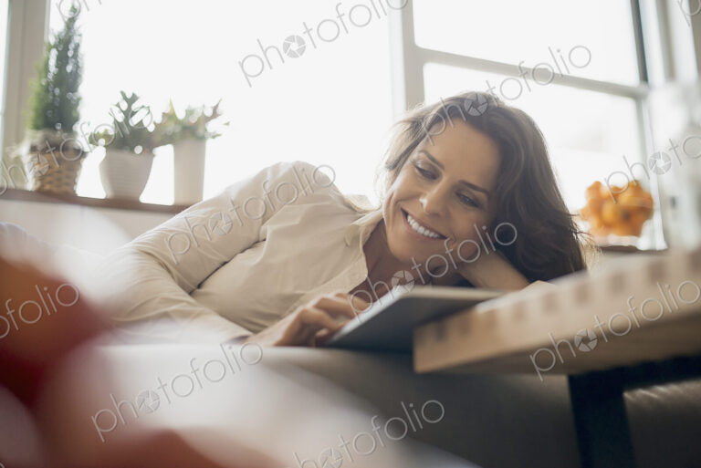 Woman at home using electronic tablet
