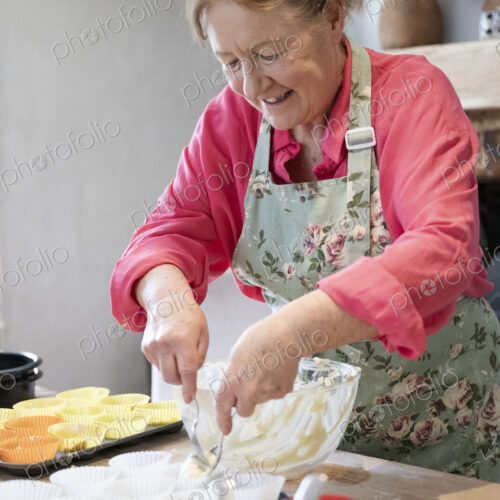 Woman baking cake in kitchen.