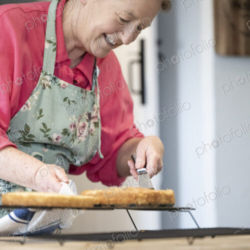 Woman baking cake in kitchen.