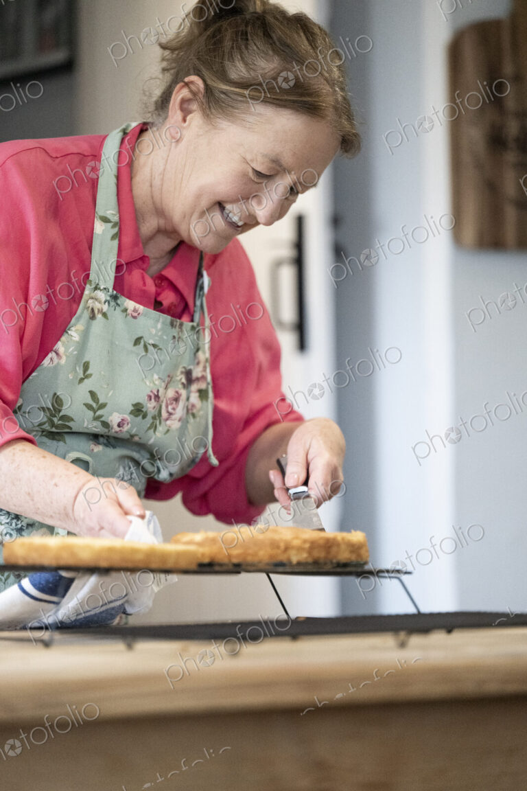 Woman baking cake in kitchen.