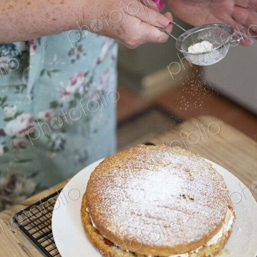 Woman baking cake in kitchen.