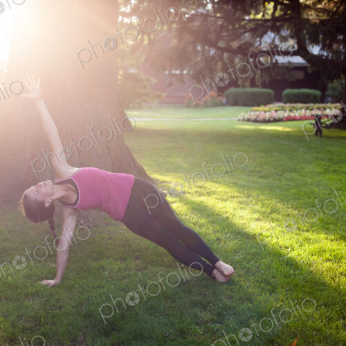 Woman balancing in yoga pose in park. Woman balancing in yoga pose in park.
