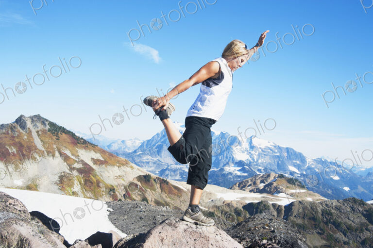 Woman doing balancing yoga pose on Mount Baker, Snoqualmie National Forest, North…