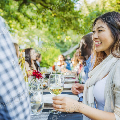 Woman enjoying wine at party outdoors Woman enjoying wine at party outdoors