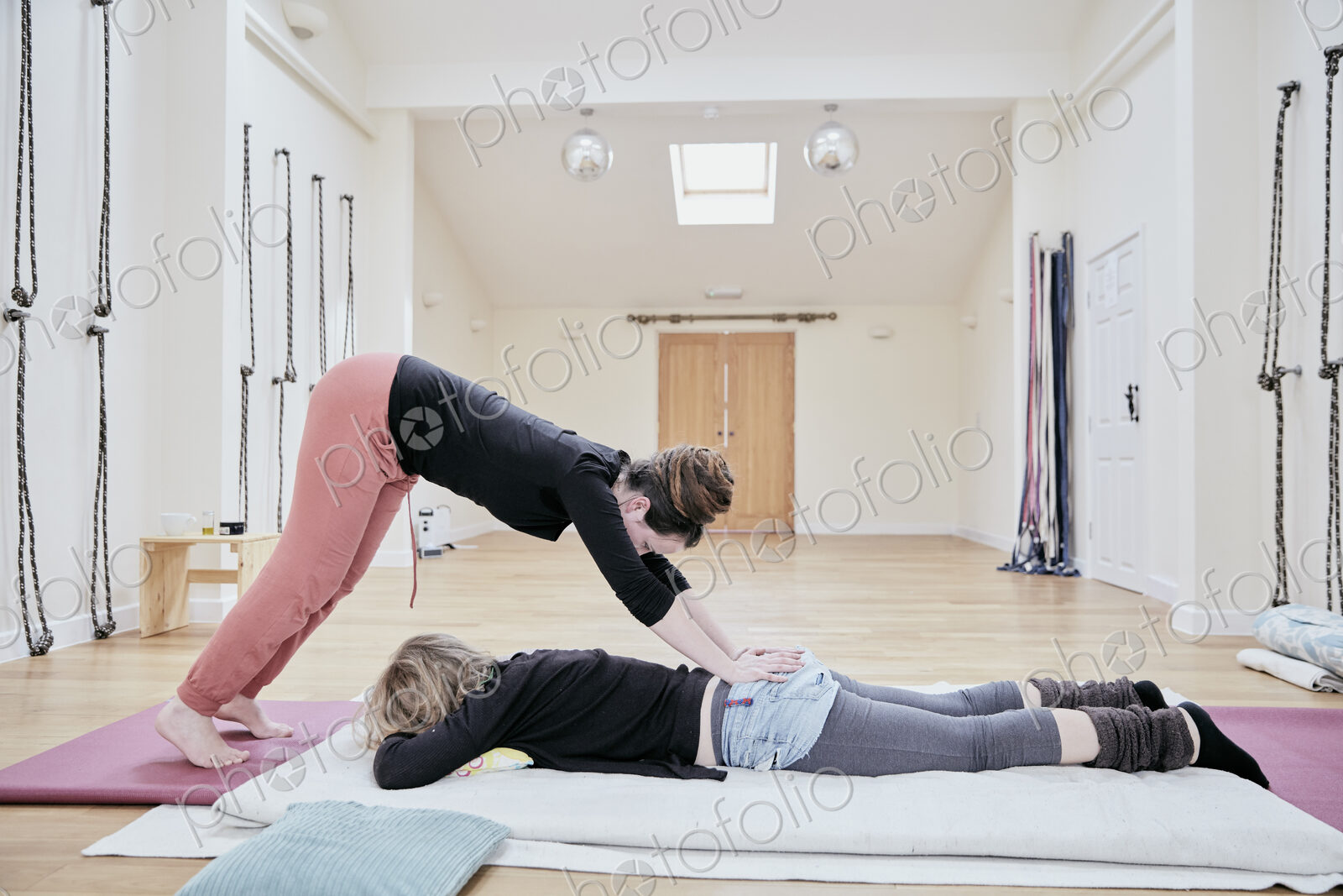 Woman having a Thai massage from a masseur.