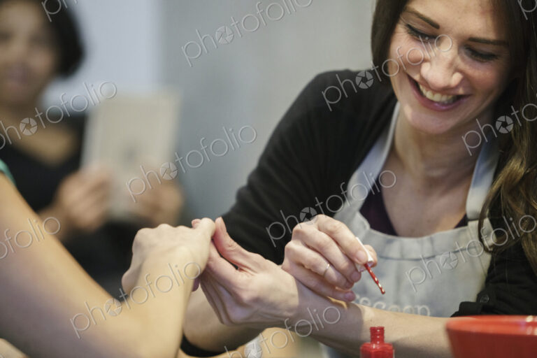 Woman having her nails painted in a nail salon.