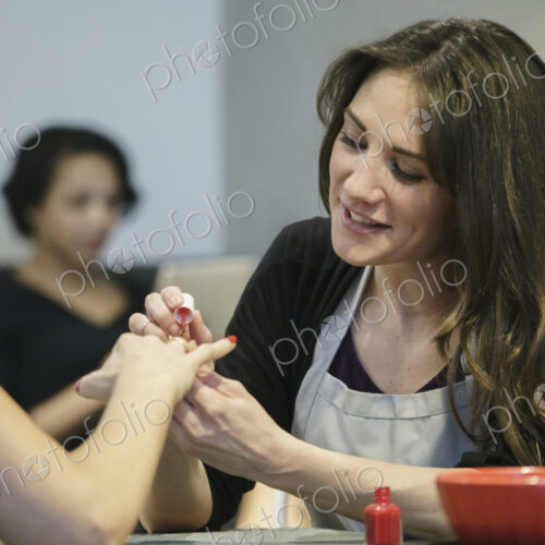 Woman having her nails painted in a nail salon. Woman having her nails painted in a nail salon.
