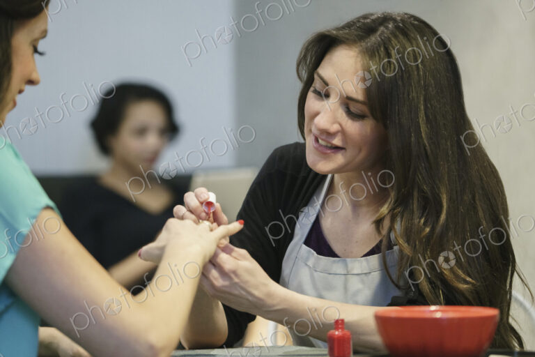 Woman having her nails painted in a nail salon.
