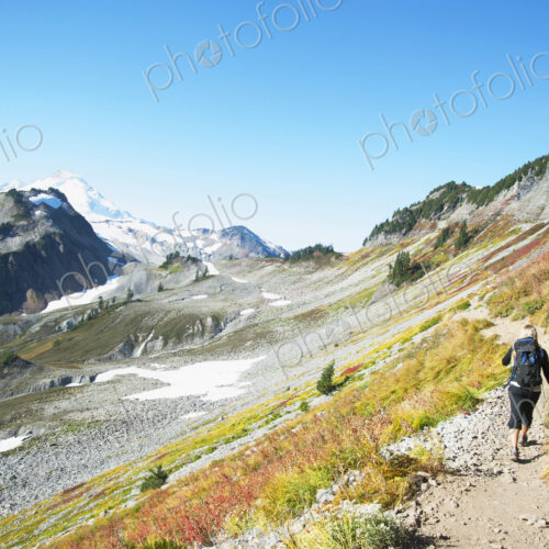 Woman hiking on rocky trail on remote hillside