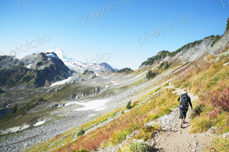 Woman hiking on rocky trail on remote hillside