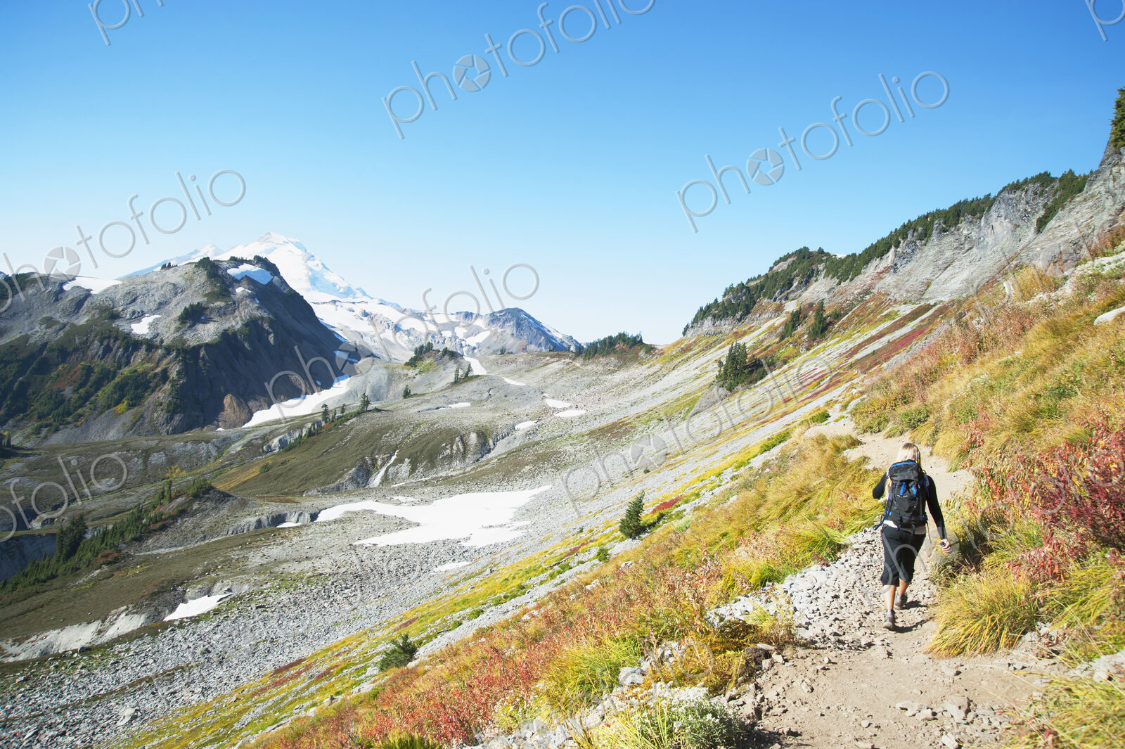 Woman hiking on rocky trail on remote hillside