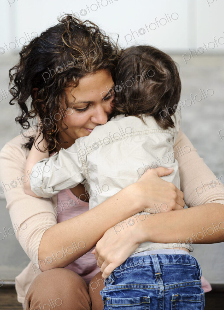 Woman hugging a boy, mother and sun.