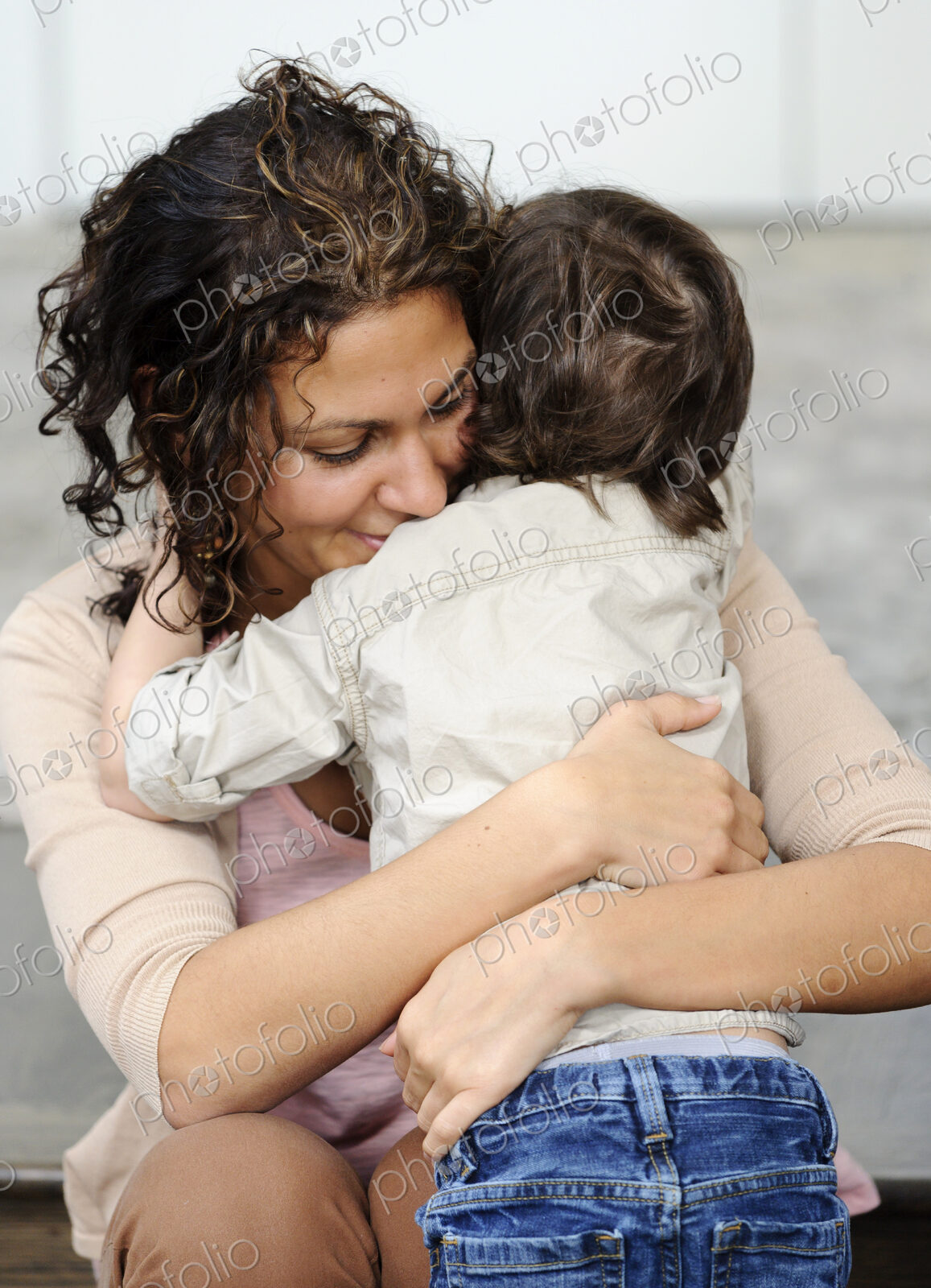 Woman hugging a boy, mother and sun.