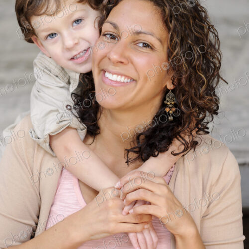 Woman hugging a boy, mother and sun laughing. Woman hugging a boy, mother and sun laughing.