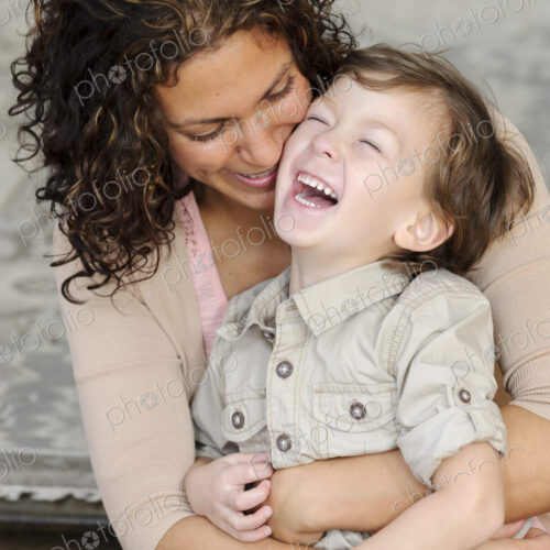 Woman hugging a boy, mother and sun laughing. Woman hugging a boy, mother and sun laughing.