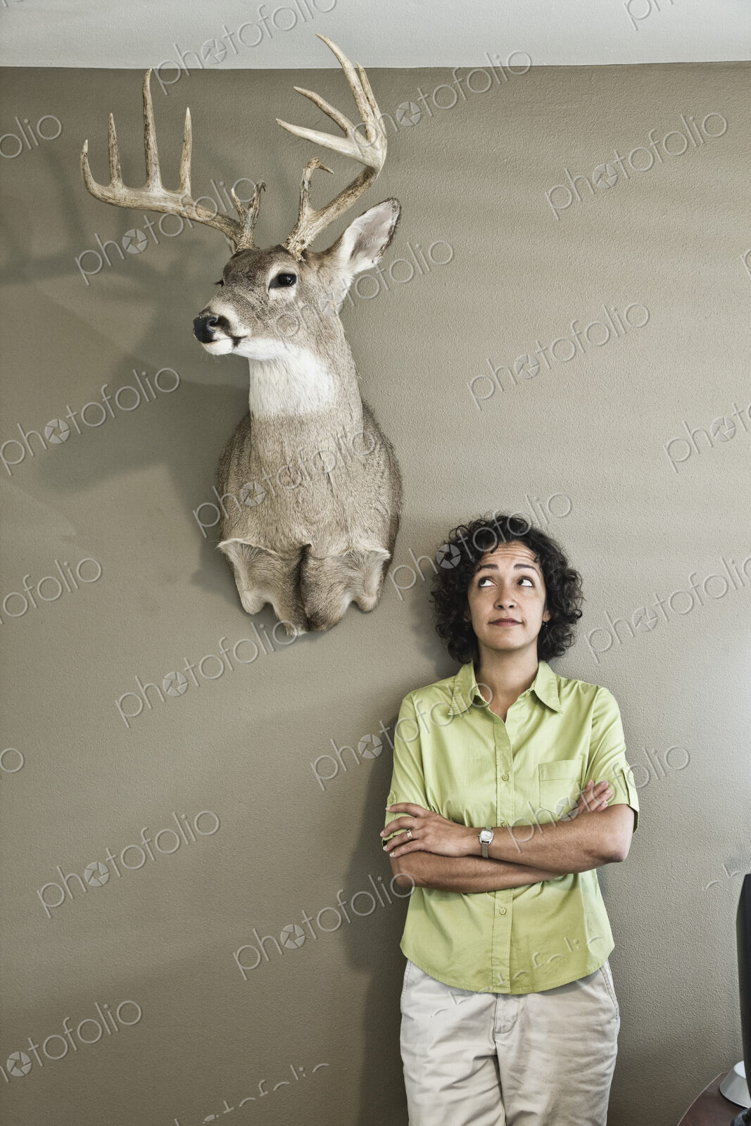 Woman in an office with a mounted deer head.