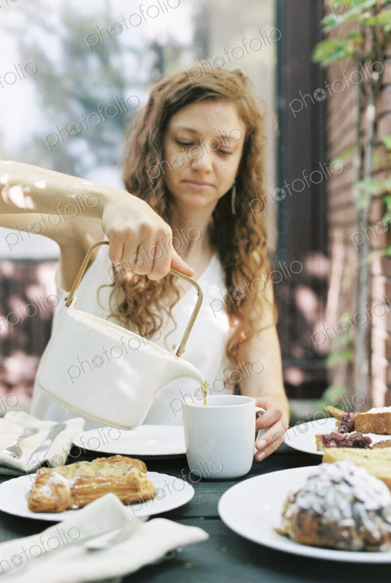 Woman pouring a cup of tea.