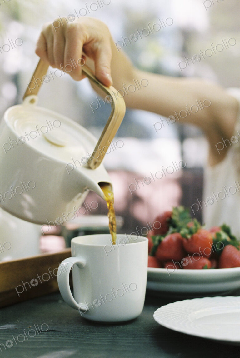 Woman pouring a cup of tea.