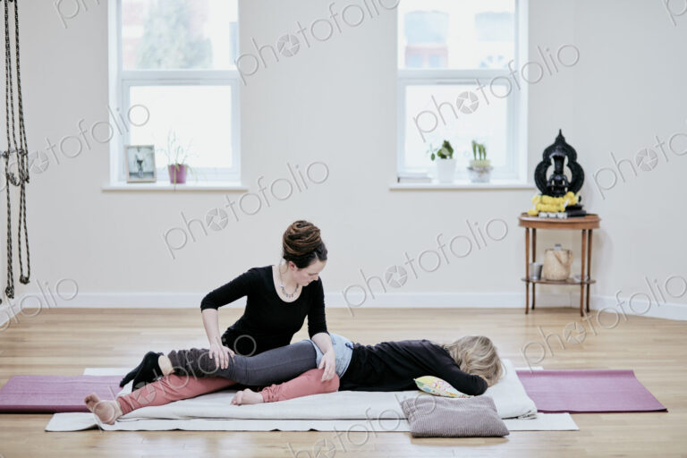 Woman receiving a Thai massage from a practioner.