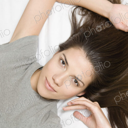 Woman reclining looking up at camera.