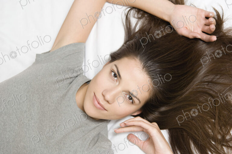 Woman reclining looking up at camera.