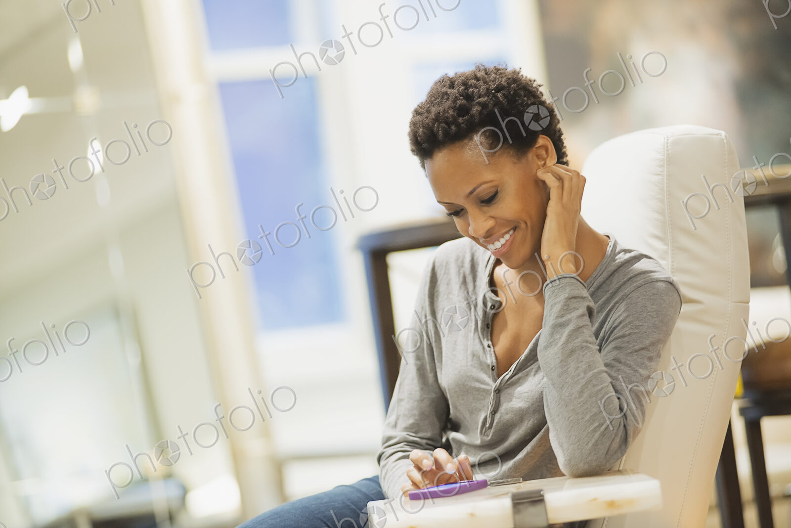 Woman relaxing at home using smartphone