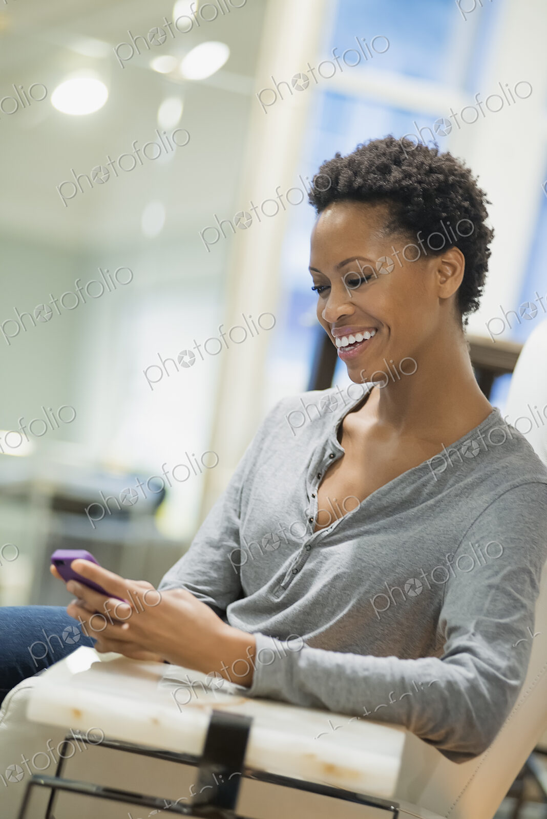 Woman relaxing at home using smartphone