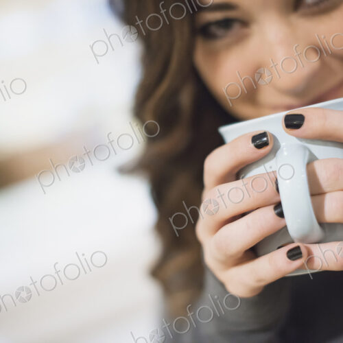 Woman relaxing at home with coffee