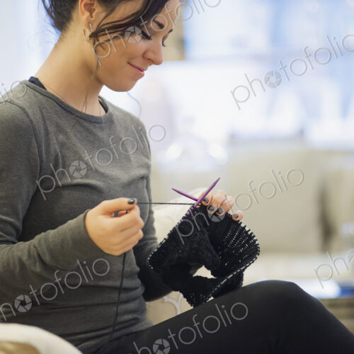 Woman relaxing at home with knitting Woman relaxing at home with knitting