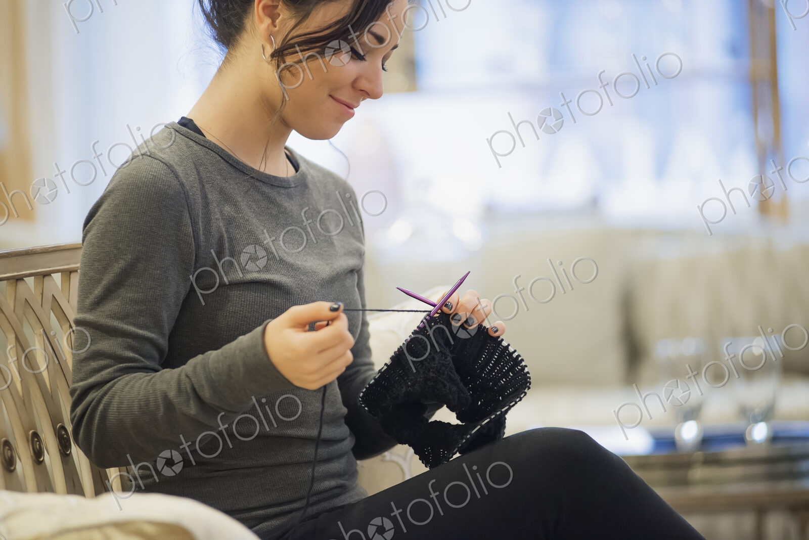 Woman relaxing at home with knitting