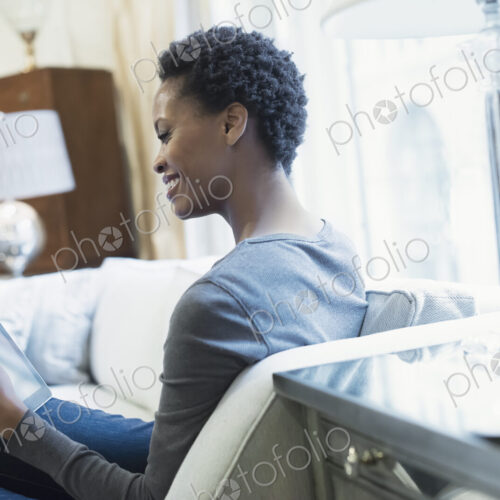Woman relaxing at home with tablet Woman relaxing at home with tablet